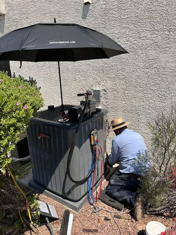 HVAC technician performing outdoor AC maintenance in Upper Gwynedd