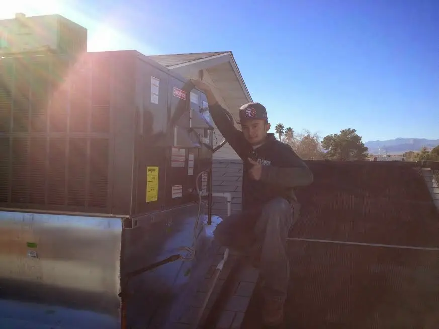 HVAC technician performing HVAC Inspection on a rooftop unit in Upper Gwynedd
